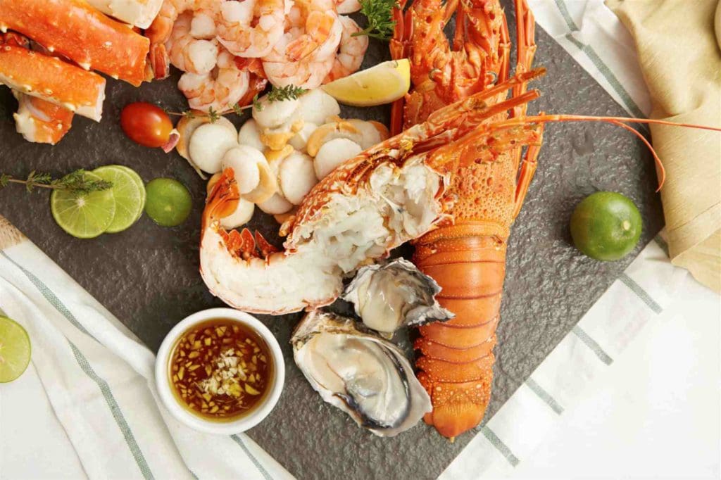 boiled and buttered lobster with lemon and calamansi slices.