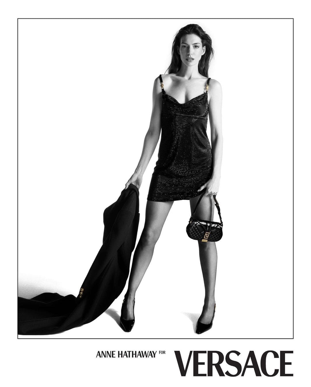 Anne Hathaway in the black Versace jersey dress with Medusa medallions