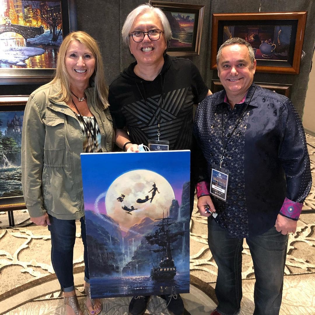 Gonzalez posing with collectors of his work