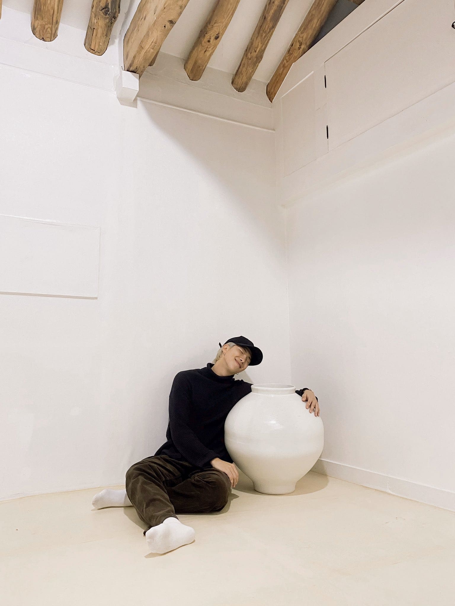 TS member RM posing with one of his Joseon dynasty moon jar
