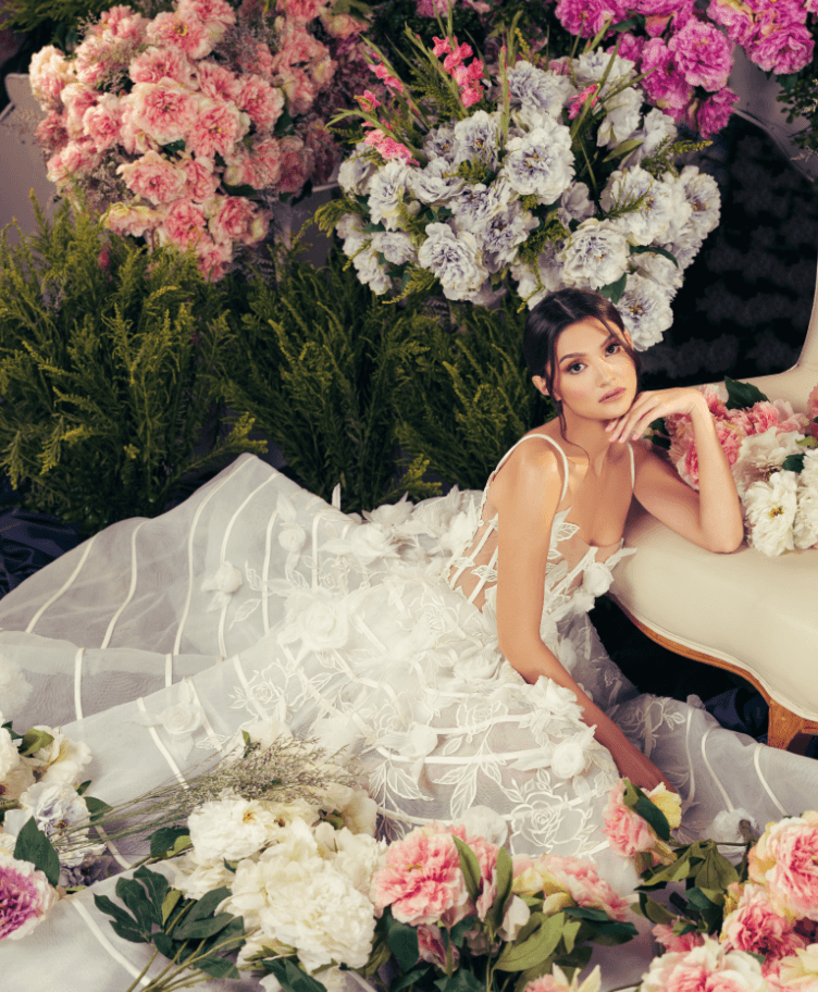 Ivory gown with sheer French corset and ballgown skirt embellished with layers of gossamer tulle, adorned with handcrafted roses and embroidery details, by JO RUBIO.