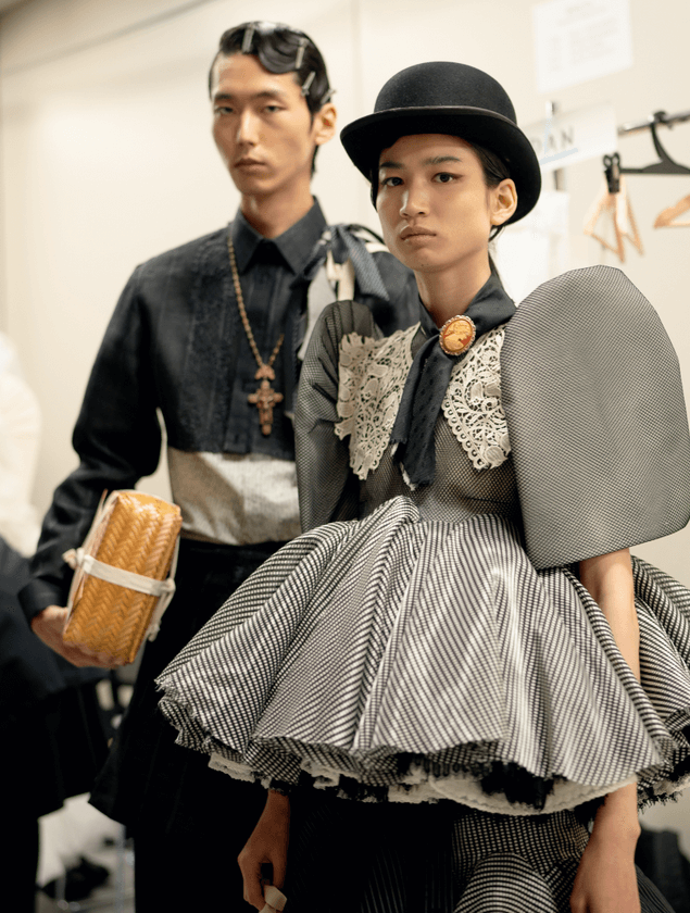 Models showcasing designs that blend components from traditional menswear and womenswear
