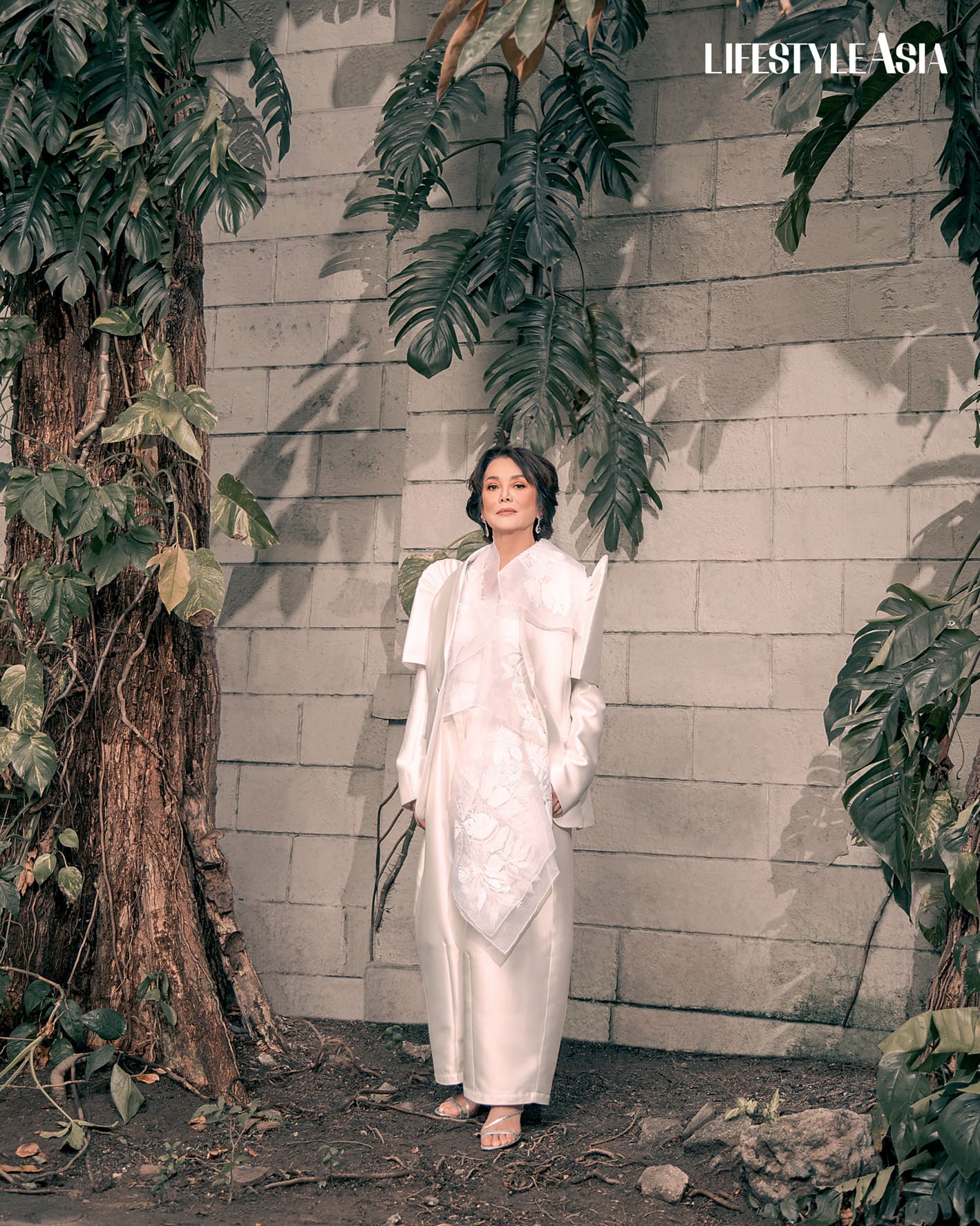 White jusi embroidered vest and mikado satin pants, RAJO LAUREL; Diamond drop earrings, JMA JEWELRY.