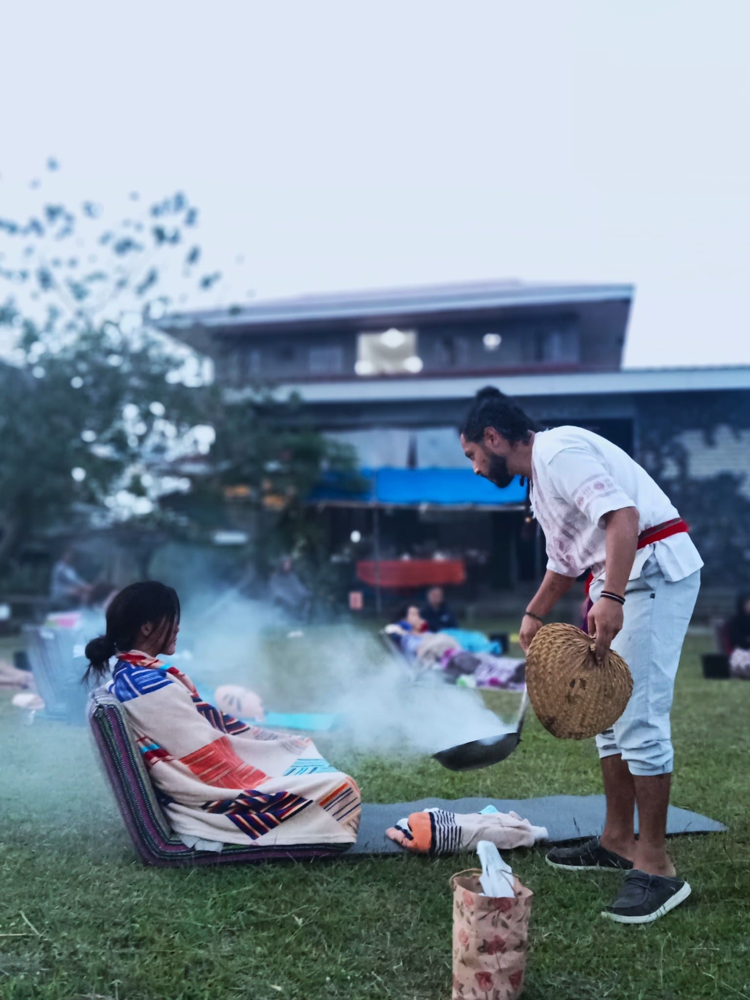 A member undergoes smoke protection in the rites