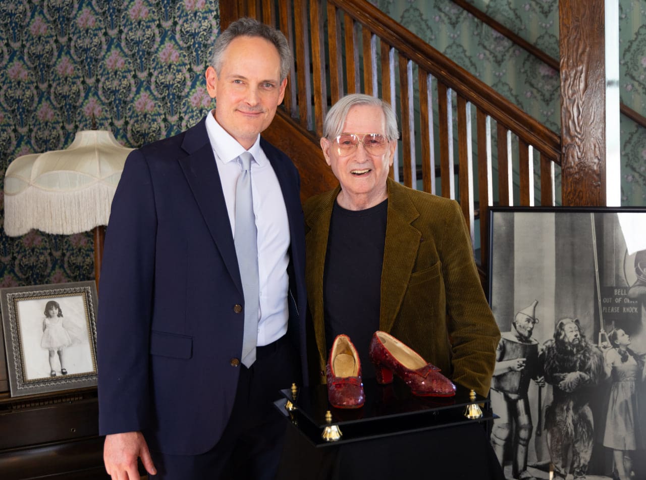 Heritage Auctions’ Senior Director of Hollywood and Entertainment Brian Chanes with Garland’s ruby slippers’ current owner, Shaw