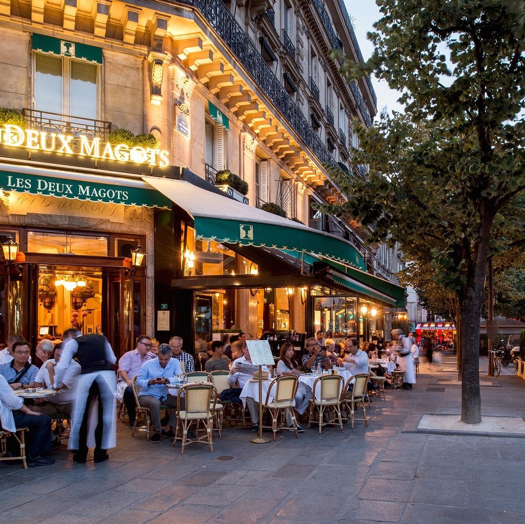 Les Deux Magots in 1965 (left) and 2023 (right)