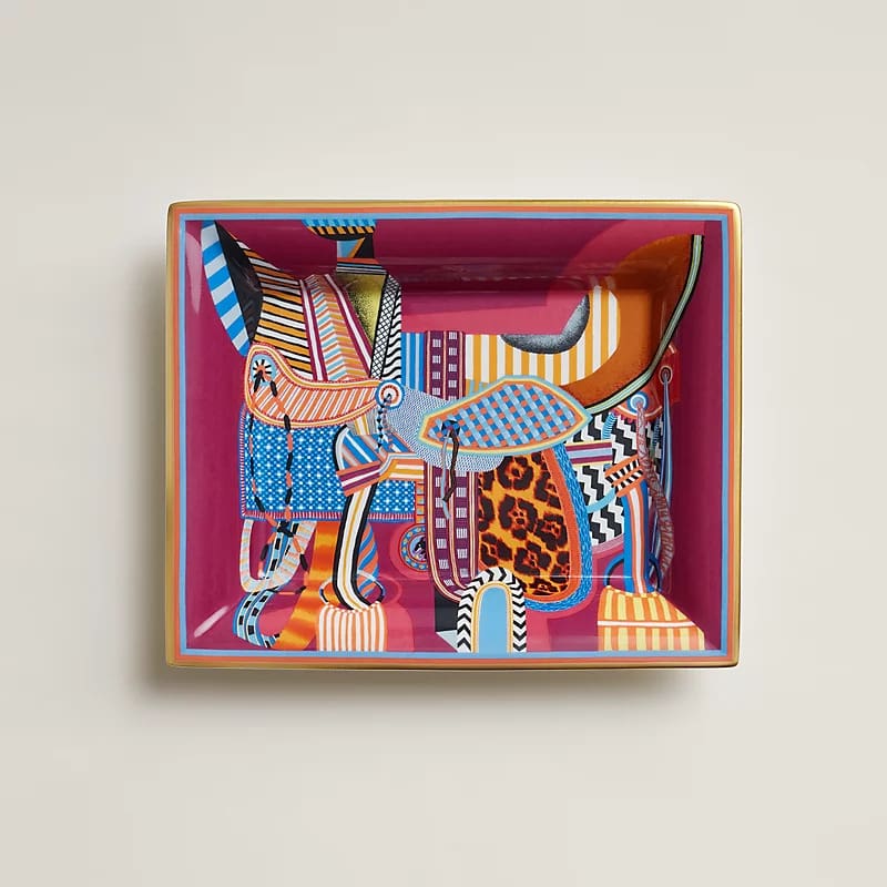 LEFT: Hérmes’ Grand Tralala pillow; RIGHT: Selle Imaginaire change tray
