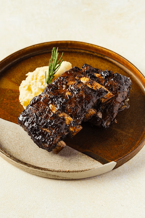 TOP (L-R): Beef Tomahawk; Slow Cooked Truffle Honey Iberico Pork Ribs. LEFT (L-R): Yellowfin Tuna Carpaccio; Parmesan Cheese and Bacon Croquetas.