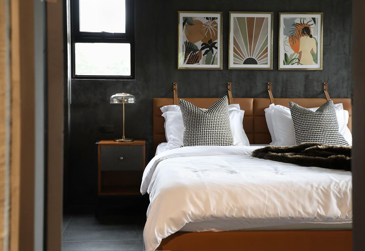 LEFT: From concept to design implementation, applying a masterful mix of materials is key to create an ambiance that evokes a comfortable and moody environment/Photo by Arthur Tselishchev. RIGHT: A textured wall complements the modular cabinetry in this contemporary style kitchen/Photo by Jar Concengco.