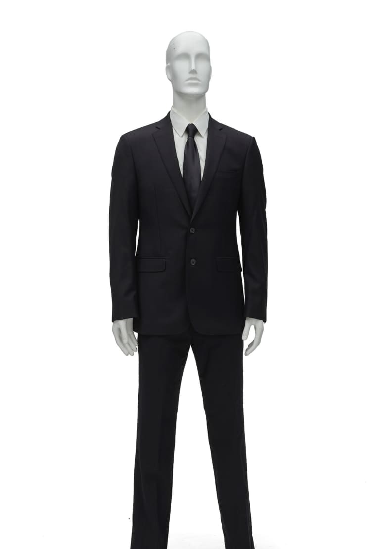 JFK Jr.’s Calvin Klein suit and black tie