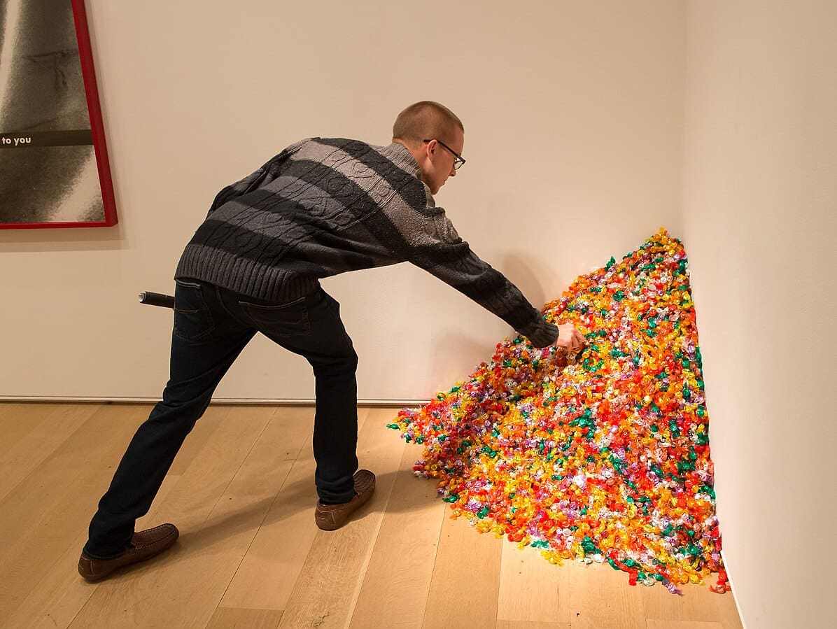 A visitor picking from “Untitled (Portrait of Ross in L.A.)"