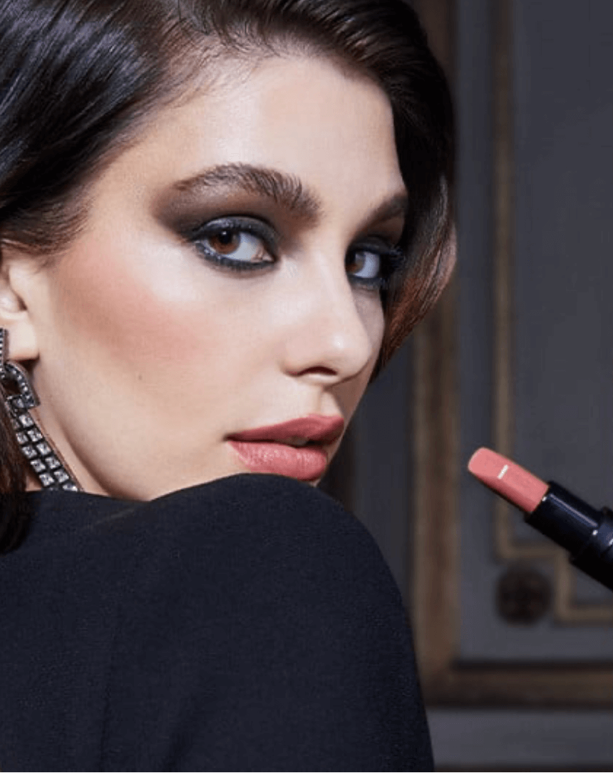 Model wearing NARS Explicit Lipstick in light pink