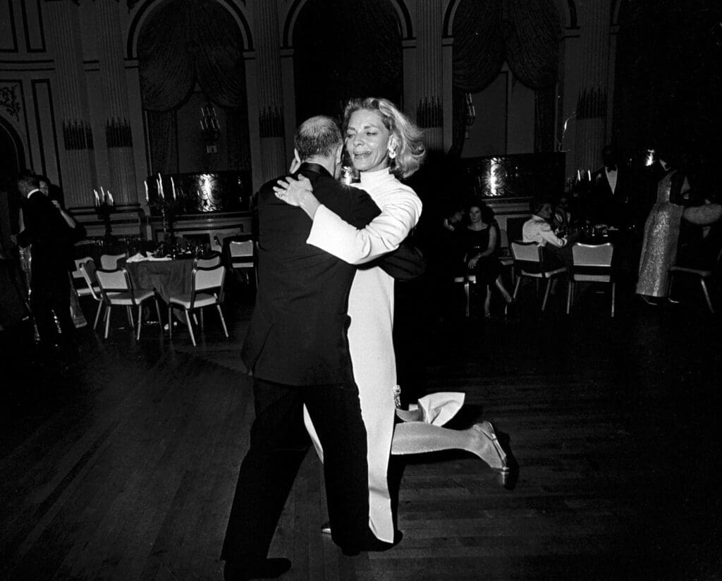 Lauren Bacall and Jerome Robbins still dancing as the party winds down; A masked Frank Sinatra and his then-wife, Mia Farrow parties