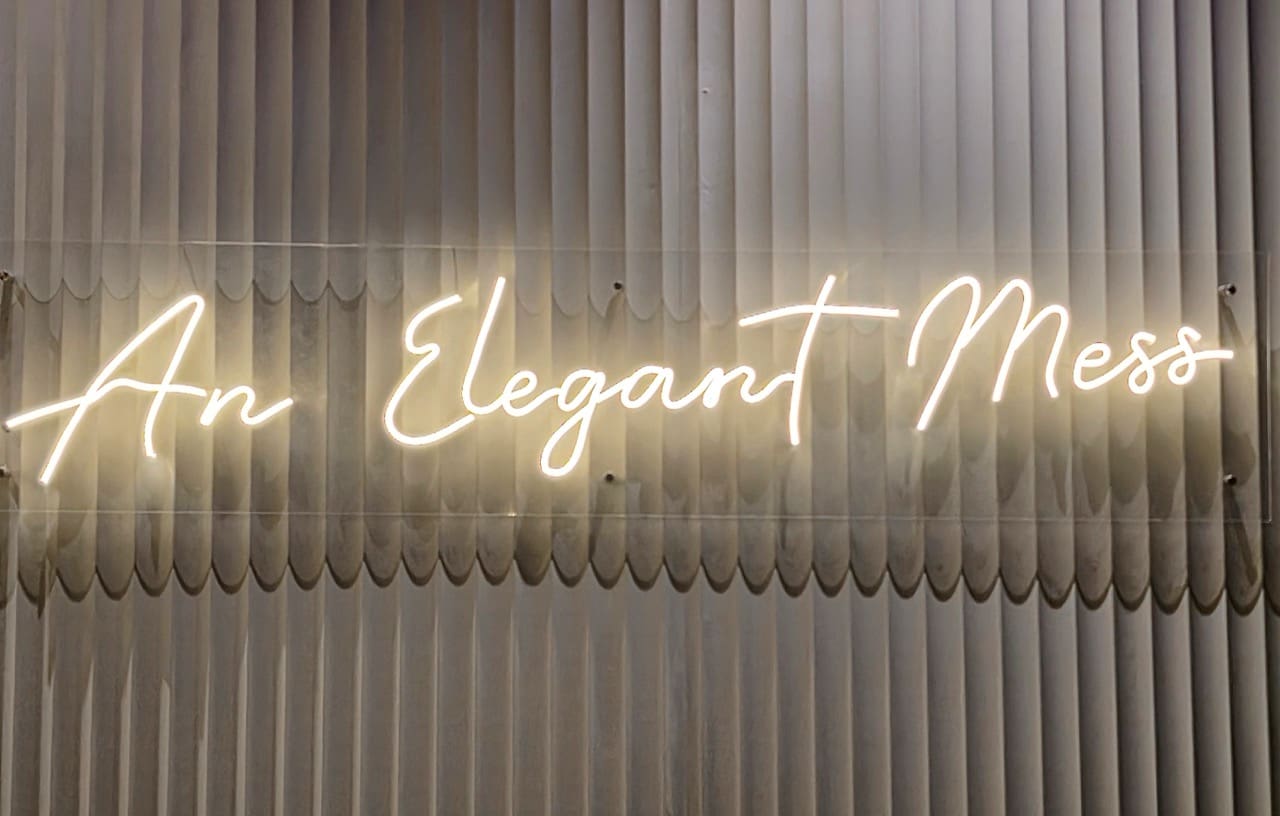 A sign inside the new Burger & Lobster embodies the restaurant's lively atmosphere that encourages diners to eat with their hands, relish in the "elegant mess," and indulge
